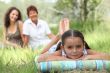 girl relaxing in park with mother and grandma