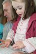 Young girl using a computer keyboard