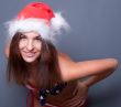 20-25 years old beautiful woman in christmas hat and swimsuit