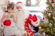 Christmas theme: Santa Claus and little girl having a fun. 