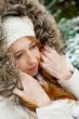 Portrait of pretty girl at winter background wearing warm clothes.