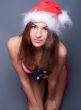 20-25 years old beautiful woman in christmas hat and swimsuit.
