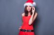 20-25 years od beautiful woman in christmas dress posing against