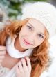 Portrait of beautiful young red hair woman outdoors in winter lo