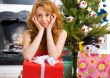 Christmas woman near a Christmas tree holding big gift box while