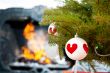 Christmas baubles against burning flame in fireplace on christma