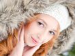Portrait of pretty girl at winter background wearing warm clothe