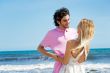 Young couple at beach, embracing, side view. Natural emotions. H