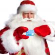 Traditional Santa Claus holding and sowing credit card while giv
