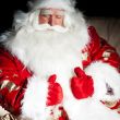 Santa sitting with a sack indoor at dark night room