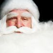Santa Claus portrait smiling isolated over a black background