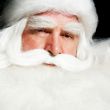 Santa Claus portrait smiling isolated over a black background