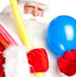 Traditional Santa Claus holding balloons for children. Isolated 