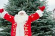 Portrait of Santa Claus standing with open hands outdoors at chr