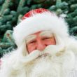 Portrait of natural Santa Claus standing at Christmas Tree outdo