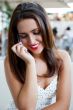 Closeup portrait of a pretty young female sitting at cafe in mor