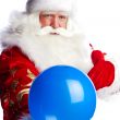 Traditional Santa Claus holding balloons for children. Isolated 