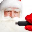 Traditional Santa Claus holding 3g usb modem in his arm on foreg