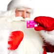 Traditional Santa Claus holding and sowing credit card while giv