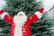 Portrait of Santa Claus standing with open hands outdoors at chr