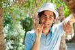 Young man wearing hat and casual clothes in sunny day. Leaning o