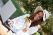 Young elegant woman wearing straw hat and white dress holding cr