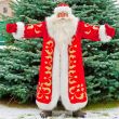 Full Length Portrait of Santa Claus standing with open hands out