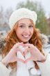 Portrait of beautiful young red hair woman outdoors in winter lo