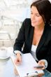 Business woman working with documents while having lunch or brea