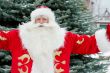 Portrait of Santa Claus standing with open hands outdoors at chr