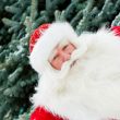Portrait of natural Santa Claus standing at Christmas Tree outdo