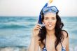 Young hispanic woman with wet skin and with a snorkel standing o