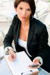 Business woman working with documents while having lunch or brea