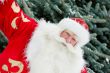 Portrait of natural Santa Claus standing at Christmas Tree outdo