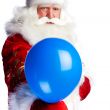 Traditional Santa Claus holding balloons for children. Isolated 
