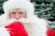 Portrait of Santa Claus standing with hand on chin outdoors at c