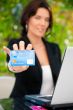 Business woman making payments online using laptop and credit ca