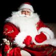 Santa sitting with a sack indoor at dark night room