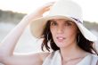 Summer portrait of beautiful woman wearing hat. Vacation at warm