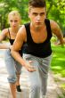 Closeup Portrait of Young Couple Jogging In Park