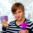 Portrait of young man inside shopping mall standing relaxed and 