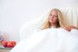 Portrait Of Young Woman Relaxing On Bed