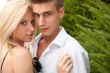 Young couple playing around in the nature - side view. Lots of c