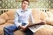 Closeup portrait of young man with newspaper 
