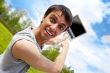 Happy young man with a laptop outdoors