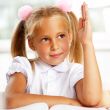Portrait of a young girl in school at the desk.