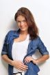 Portrait of a beautiful young woman wearing a denim shirt with h