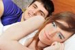 Young man and woman in bed. Couple.