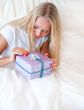 Bedroom surprise present - young happy woman in bedroom