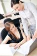 Portrait of two pretty women in an office environment working to